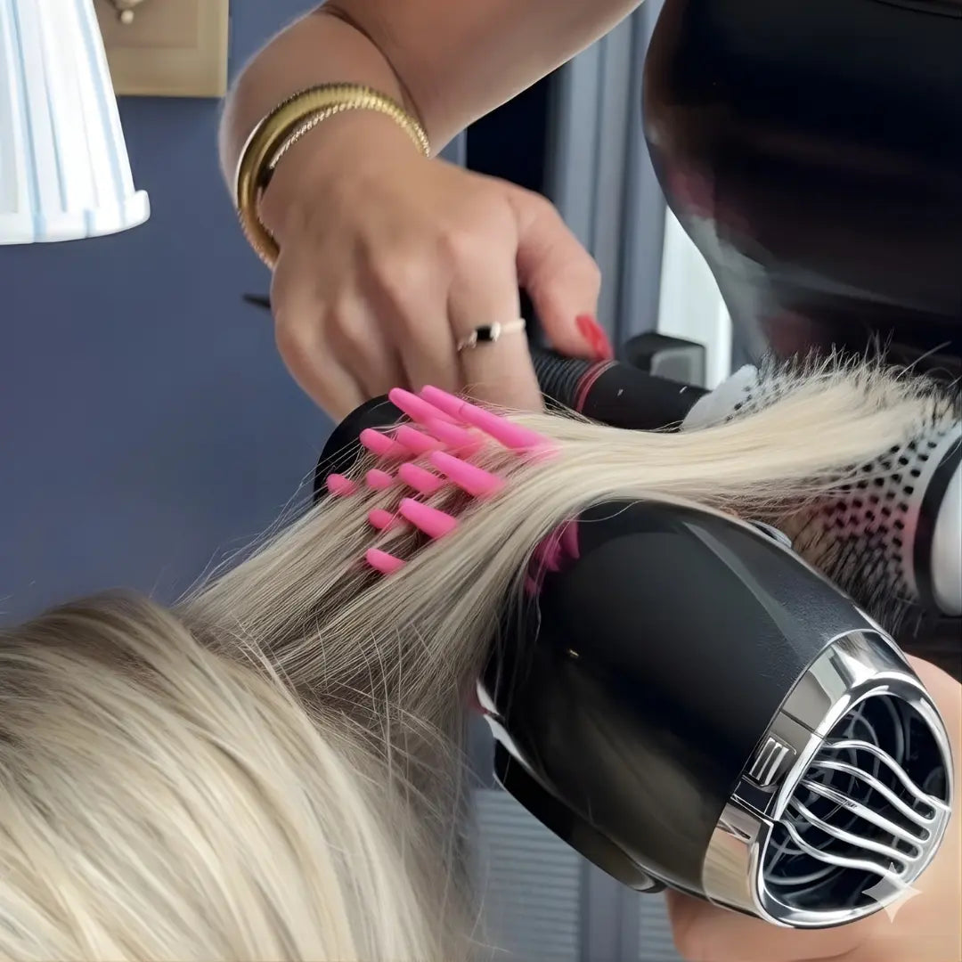 Person using a hair dryer and brush with dryspike blowout tool on a person's hair indoors.